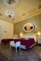 A bed or beds in a room at Palazzo degli Affreschi