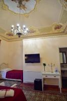 A bed or beds in a room at Palazzo degli Affreschi
