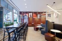 a restaurant with a long table and chairs at NU Hotel in Brooklyn