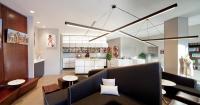 a living room with a couch and a kitchen at NU Hotel in Brooklyn