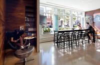 a group of people sitting in chairs in a restaurant at NU Hotel in Brooklyn