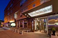 a group of tables outside of a building at night at NU Hotel in Brooklyn
