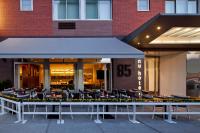 a restaurant with tables and chairs in front of a building at NU Hotel in Brooklyn