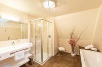 a bathroom with a shower and a sink at Hotel Mader in Steyr