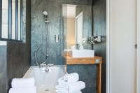 a bathroom with a tub and a sink and a mirror at Best Western Hotel De La Plage Saint Marc sur Mer in Saint-Nazaire