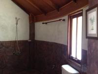 a bathroom with a shower and a toilet and a window at Malibu Beach Bungalows in Chaloklum