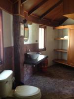 a bathroom with a toilet and a sink at Malibu Beach Bungalows in Chaloklum