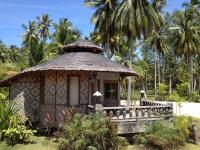 a small hut in a garden with palm trees at Malibu Beach Bungalows in Chaloklum