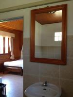 a bathroom with a sink and a mirror at Malibu Beach Bungalows in Chaloklum