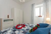 Postel nebo postele na pokoji v ubytování Apartments Luksic
