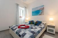 Postel nebo postele na pokoji v ubytování Apartments Luksic