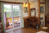 a bathroom with a toilet and a desk on a balcony at Cingjing Vienna Pleasance Cottage in Ren&#39;ai