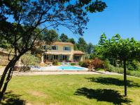 a house with a pool and a yard at La Bastide des Cairns in Seillans