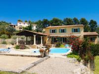 a villa with a swimming pool and a house at La Bastide des Cairns in Seillans
