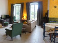 a living room with a couch and a table and chairs at Holiday Home Le chant des milans by Interhome in Ondres