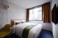 a hotel room with a bed and a window at ARK Hotel - Dongmen in Taipei