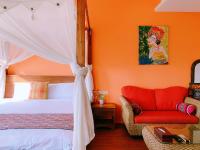 a bedroom with a bed and a red chair at Ibali Hostel in Magong