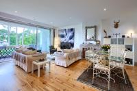 a living room with a couch and a table at Appartement Pyla Les Cèdres in Pyla-sur-Mer