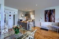 a kitchen and dining room with a glass table in a room at Appartement Pyla Les Cèdres in Pyla-sur-Mer