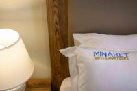A bed or beds in a room at Minaret Suites and Apartments