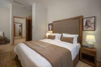 A bed or beds in a room at Minaret Suites and Apartments