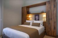 A bed or beds in a room at Minaret Suites and Apartments