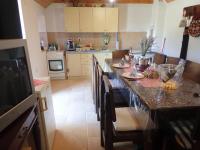 a kitchen with a long table with chairs and a counter at Holiday Home Jukići in Seline