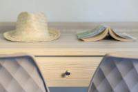 a hat and books on top of a wooden drawer at Joseph Charles in LʼÎle-Rousse