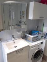 a bathroom with a washing machine and a sink at FLAB &#39; DES VENTS in Le Tréport