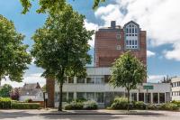 an office building with trees in front of it at Akzent City-Hotel Kleve in Kleve