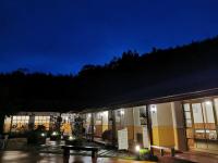 a building with a bench in front of it at night at Alishan Tea Garden B&amp;B in Fenqihu