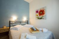 A bed or beds in a room at Kamares House Apartments & Studios