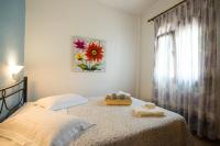 A bed or beds in a room at Kamares House Apartments & Studios