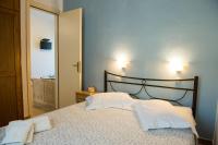 A bed or beds in a room at Kamares House Apartments & Studios