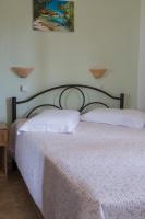 A bed or beds in a room at Kamares House Apartments & Studios