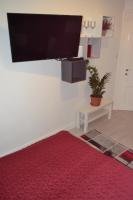 Televízia a/alebo spoločenská miestnosť v ubytovaní City Corso Apartman