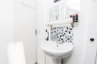 a white bathroom with a sink and a mirror at TinyHouse Inn Saint-Germain-des-Près in Paris