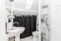 a small bathroom with a sink and a toilet at TinyHouse Inn Saint-Germain-des-Près in Paris