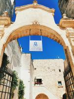an archway with a sign hanging over a building at GH Dimora Sant&#39;Anna in Carovigno