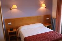 A bed or beds in a room at Hotel Santa Faz