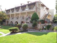 a large house with a garden in front of it at Maini Studios in Stoupa