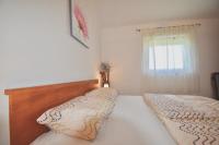 a bedroom with two beds and a window at Comfortable apartment near the Hidrobaza beach in Štinjan