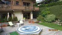 a large hot tub in the middle of a patio at Alpine Lodge 5 in Les Contamines-Montjoie