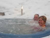 a man and a woman in a hot tub at Alpine Lodge 5 in Les Contamines-Montjoie