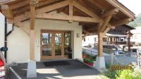 a large wooden pergola on a building at Alpine Lodge 5 in Les Contamines-Montjoie