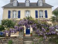 a house with purple flowers on the front of it at St Guenole&#39; Studio Apartment in Landévennec