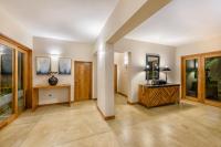 a large room with a hallway with a table and windows at Aryana Boutique Hotel in Anuradhapura