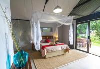 a bedroom with a bed with a canopy at Caprivi Mutoya Lodge and Campsite in Katima Mulilo