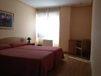 Postel nebo postele na pokoji v ubytování Apartamentos Turisticos Puerta de León