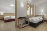 A bed or beds in a room at Hotel Krondlhof